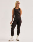 Model wearing Cuera Active Logo Tights Long in Dark Brown, front studio view