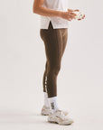 Model wearing Cuera Active Logo Tights Long in Walnut, close-up detail on model