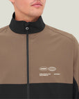 Model wearing Cuera Active Track Jacket in Black / Walnut, close-up detail on model