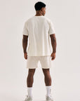 Model wearing Cuera Active WPC Light Weight T-Shirt in Off White/Walnut, back studio view