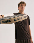 Model wearing Cuera Oncourt Airy Logo T-Shirt in Dark Brown, close-up detail on model
