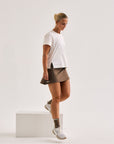 Model wearing Cuera Oncourt Cuera Skirt 2-in-1 in Walnut, front studio view