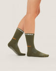 Model wearing Cuera Oncourt Grip Sock in Army, front studio view