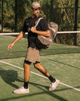 Model with Cuera Oncourt Premium Padel Bag in Walnut, lifestyle action shot on the padel court