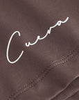 Cuera Oncourt Slit Top SS in Dark Brown, logo print detail