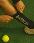 Model wearing Cuera 2-pack Bandeja Padel Socks in Black/Sand, close-up detail on model