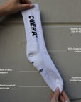 Model wearing Cuera 2-pack Cuera Padel Socks in White/Navy, close-up detail on model