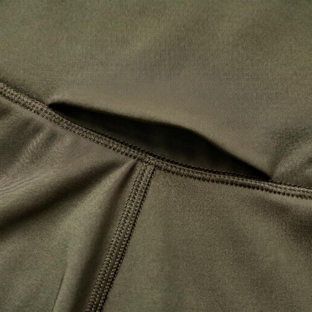 Model wearing Cuera Active Cuera Tights Hidden Front Seem in Army, front studio view