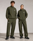Model wearing Cuera Active Cuera Track Jacket in Army, front studio view