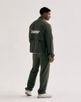 Model wearing Cuera Active Cuera Track Jacket in Army, back studio view