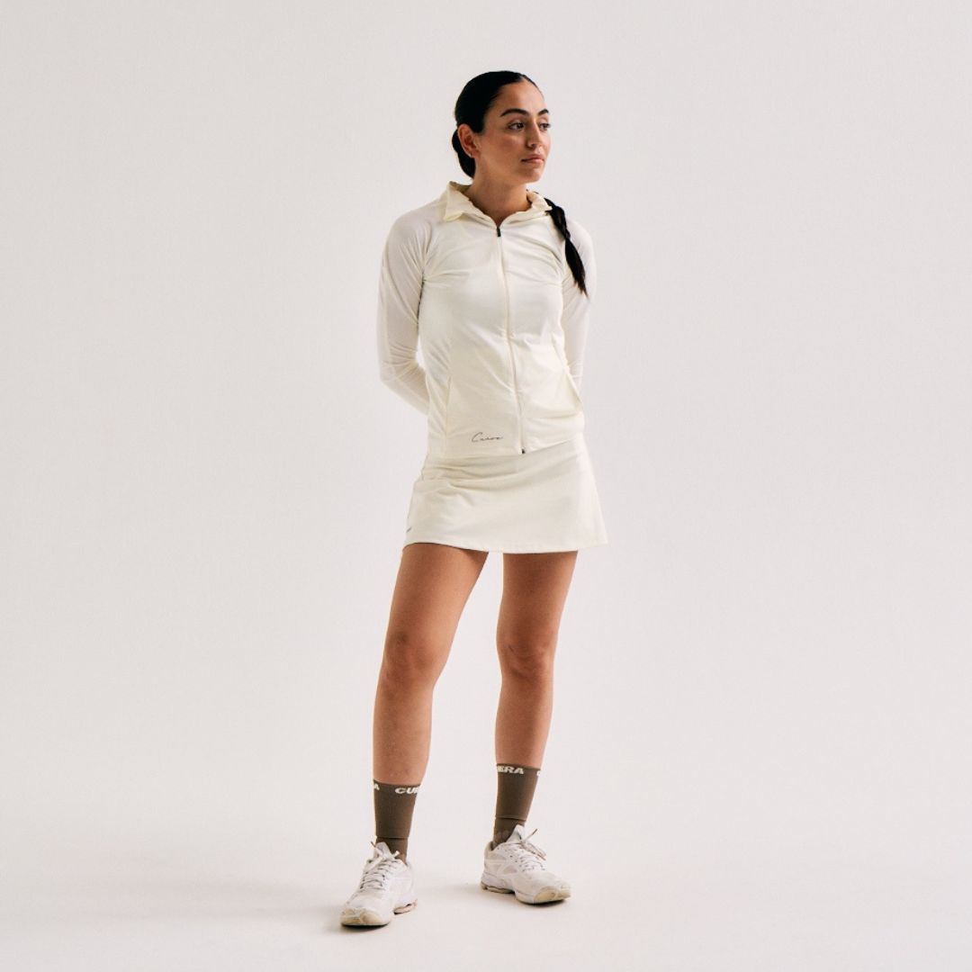 Model wearing Cuera Active Cuera Zip Cardigan in Off White, front studio view