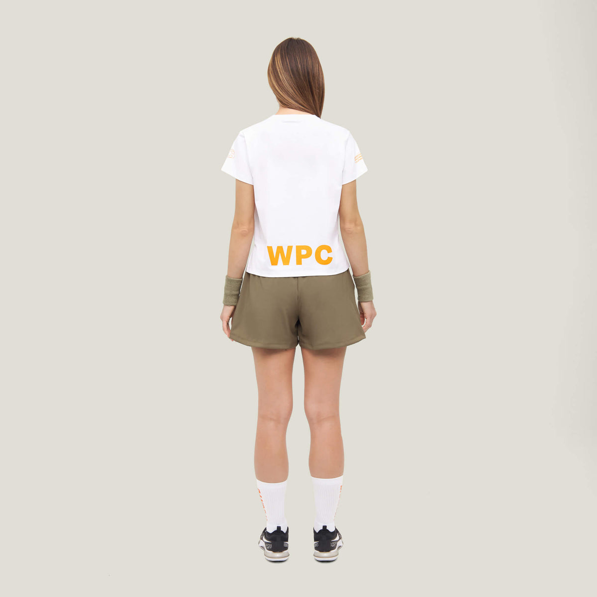 Woman wearing Cuera Womens Active Globe Shorts in Walnut, back studio view