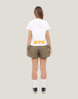 Woman wearing Cuera Womens Active Globe Shorts in Walnut, back studio view