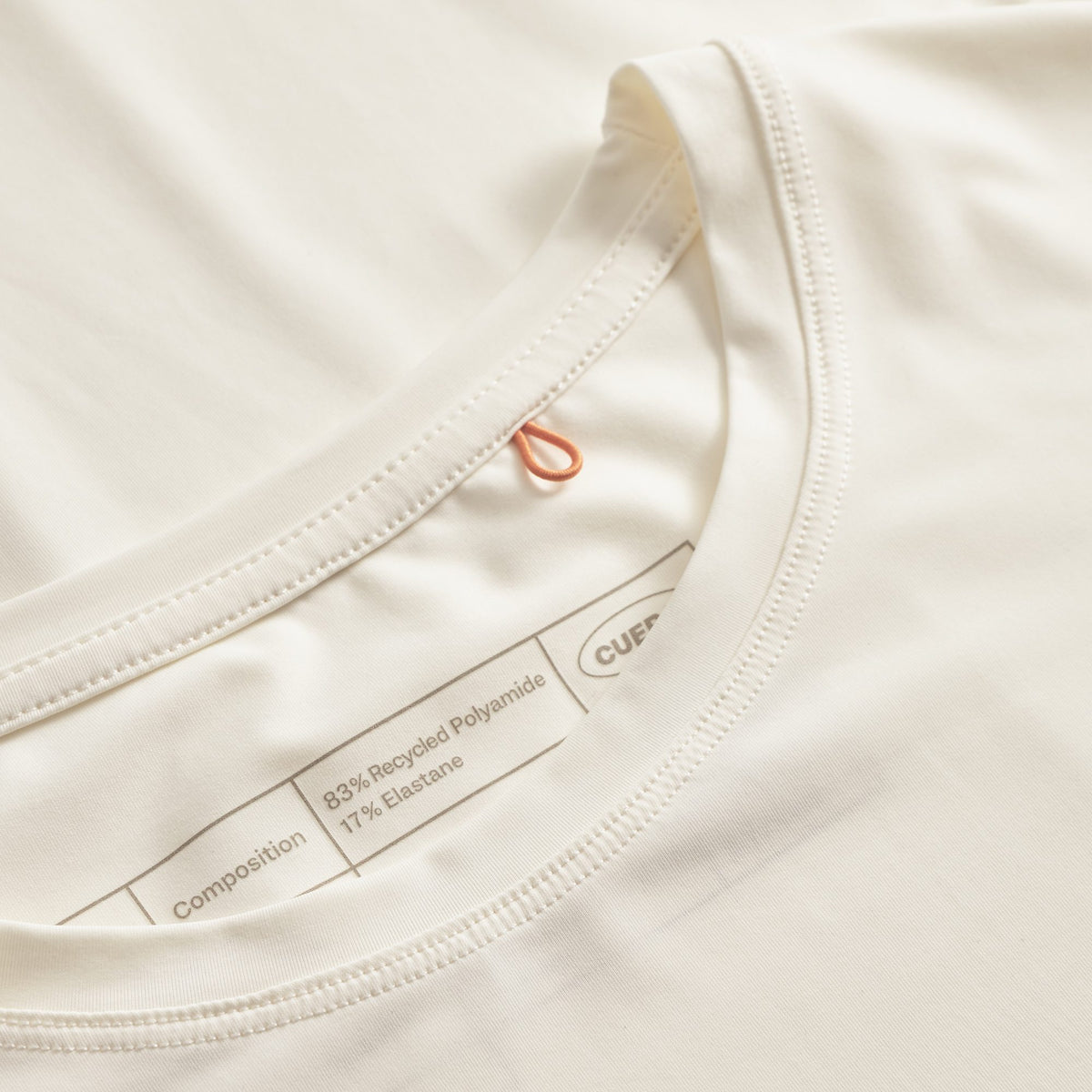 Cuera Active Light Weight T-Shirt in Off White w. Navy/Green, neck label and care tag detail