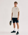 Model wearing Cuera Active Light Weight T-Shirt in Off White w. Navy/Green, front studio view