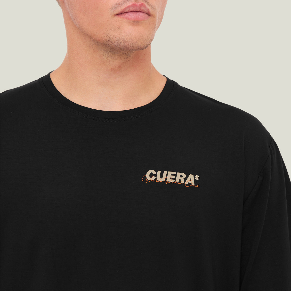 Model wearing Cuera Active Light Weight T-Shirt in Black, close-up detail on model