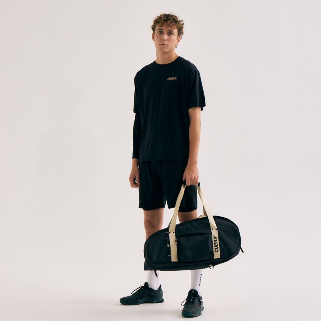 Model wearing Cuera Active Light Weight T-Shirt in Black, front studio view