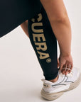 Model wearing Cuera Active Logo Tights Long in Black, close-up detail on model