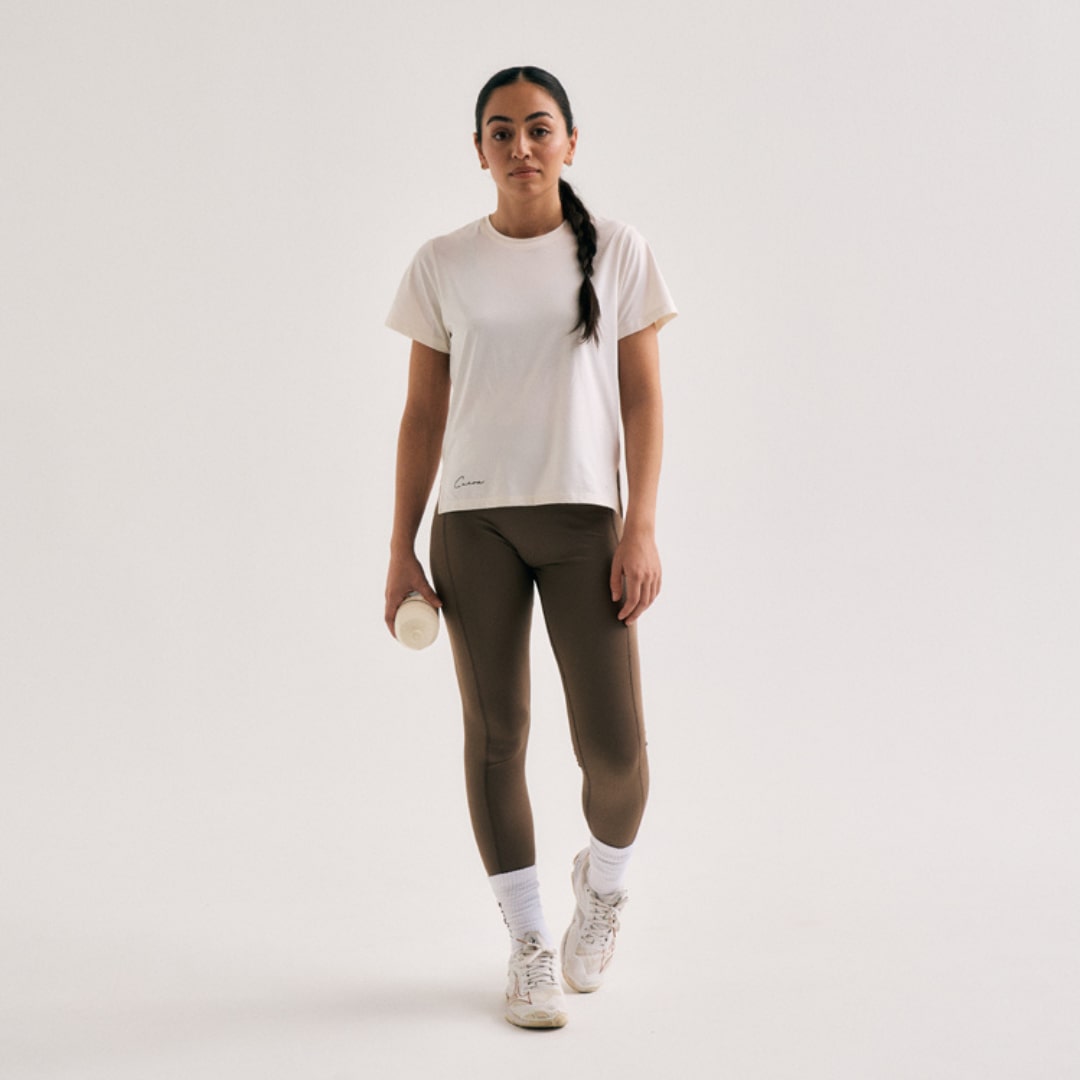 Model wearing Cuera Active Logo Tights Long in Walnut, front studio view