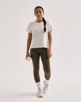 Model wearing Cuera Active Logo Tights Long in Walnut, front studio view