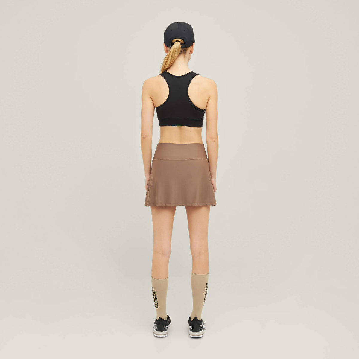 Woman wearing Cuera Active Made Bra in Black, back studio view