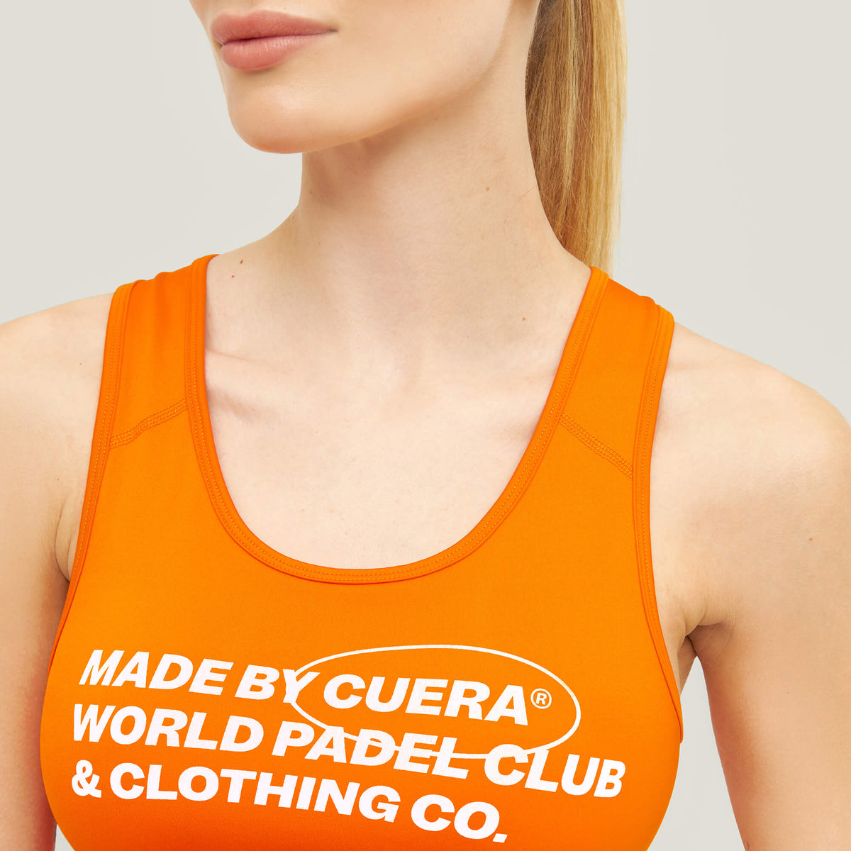 Close-up of Cuera branding on the Active Made Bra in Orange