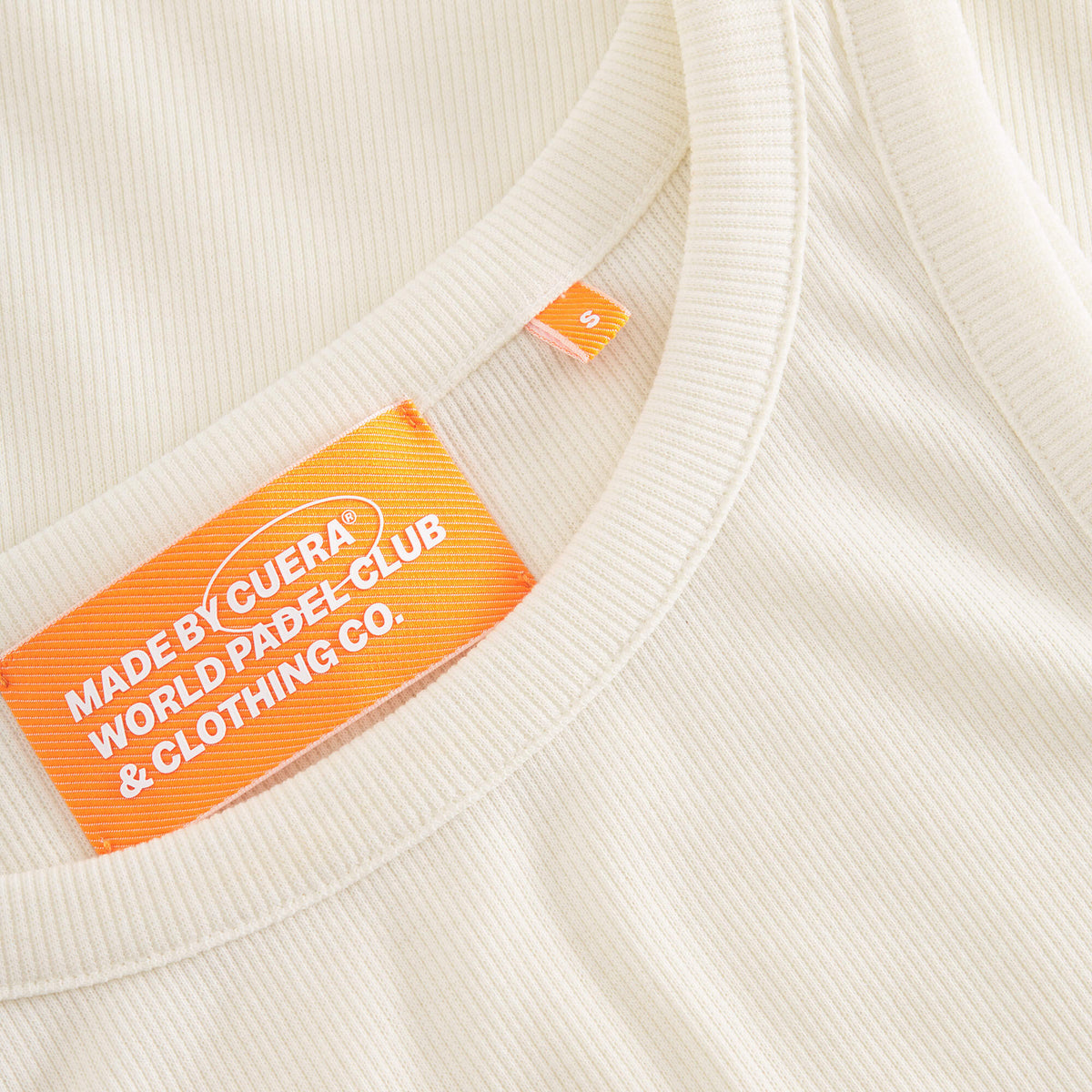 Cuera Active Rib Tank Top in Off White, neck label and care tag detail