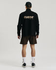 Model wearing Cuera Active Structure Half Zip in Black, back studio view
