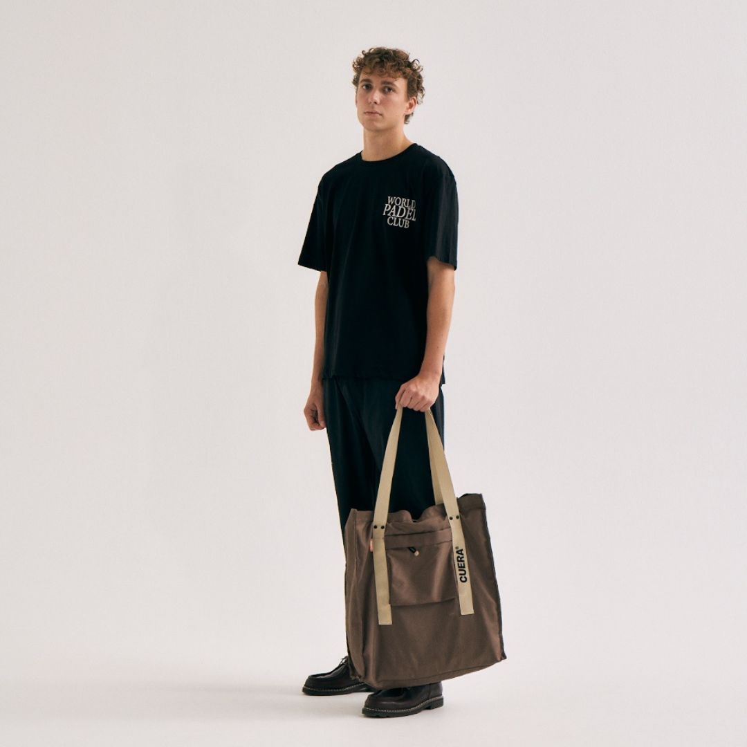 Model with Cuera Active Totebag in Walnut, lifestyle action shot on the padel court