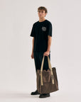 Model with Cuera Active Totebag in Walnut, lifestyle action shot on the padel court
