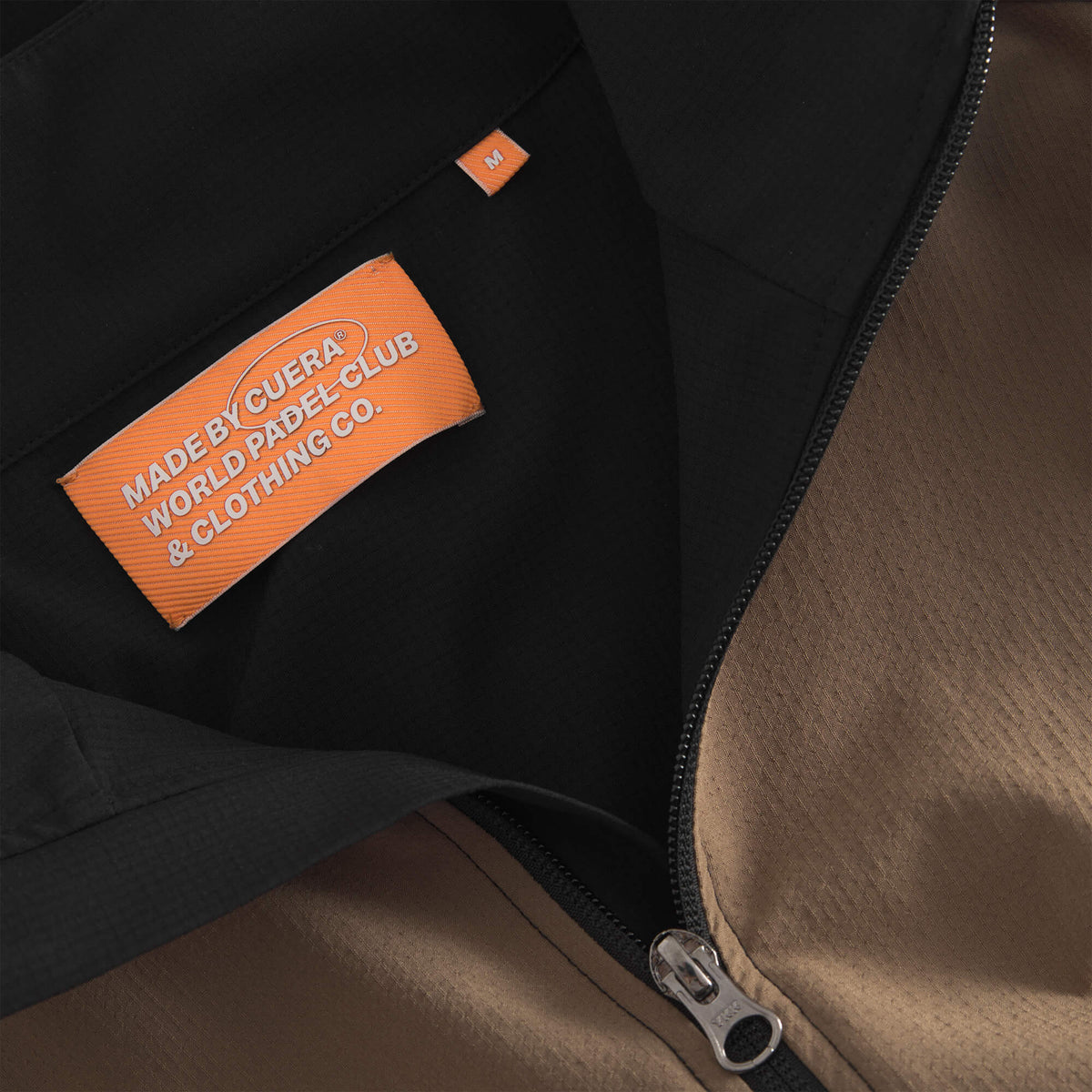 Cuera Active Track Jacket in Black / Walnut, neck label and care tag detail