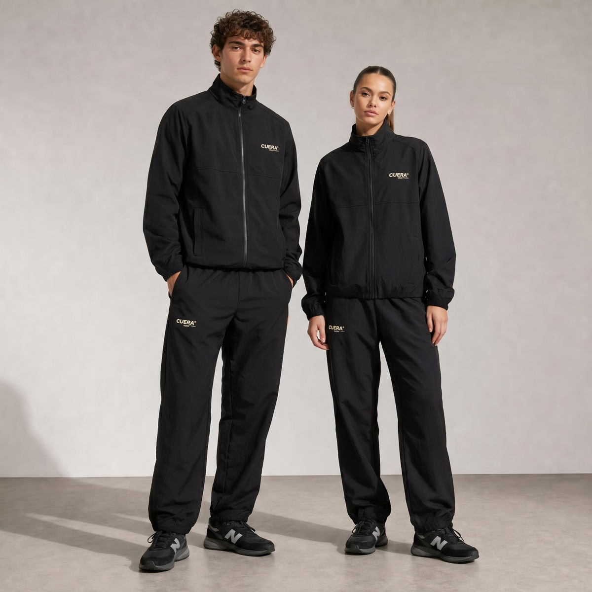 Model wearing Cuera Active Tracksuit Black 2.0 Bundle, front studio view
