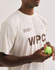 Model wearing Cuera Active WPC Light Weight T-Shirt in Off White/Walnut, close-up detail on model
