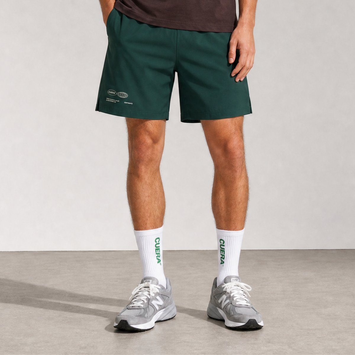 Model wearing Cuera Green shorts &amp; 2-pack socks, front studio view
