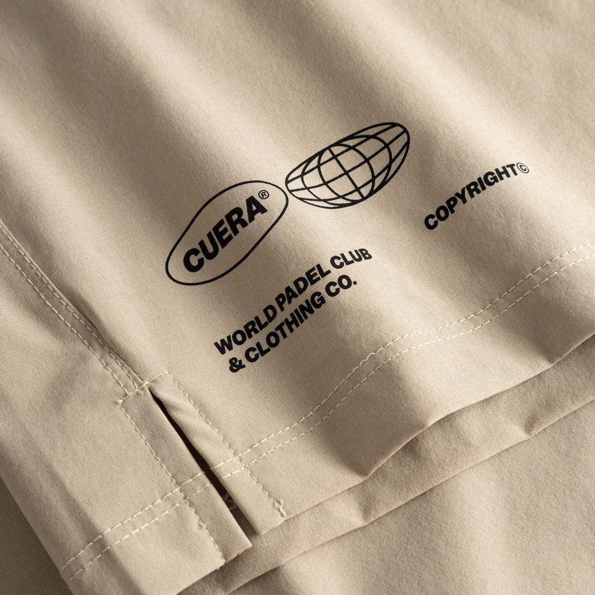 Cuera Mens Active Globe Shorts in Sand, logo print detail