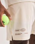 Man wearing Cuera Mens Active Globe Shorts in Off White, close-up detail on model