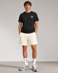 Man wearing Cuera Mens Active Globe Shorts in Off White, front studio view