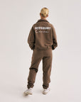 Model wearing Cuera Offcourt Cuera Sweat Pants in Walnut, back studio view