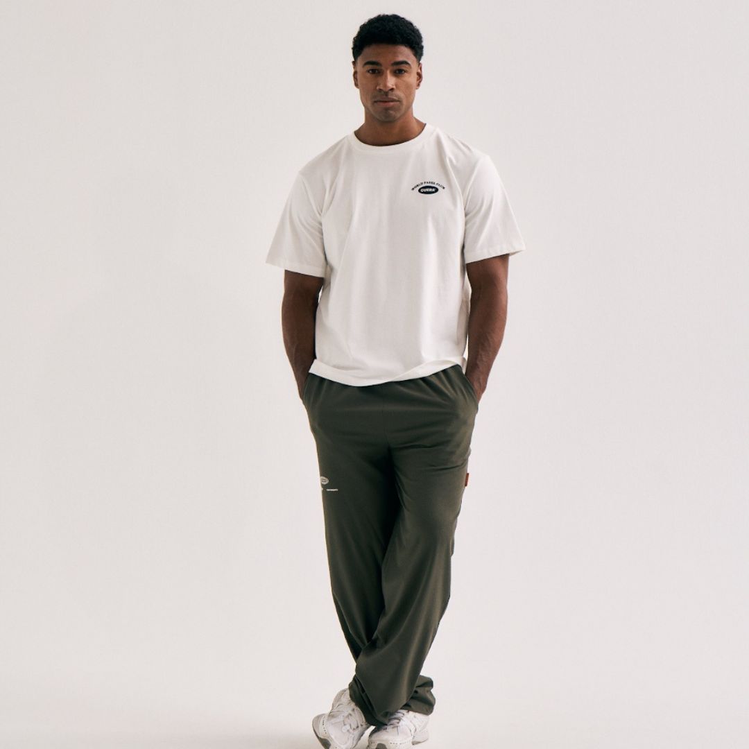 Model wearing Cuera Offcourt Legacy Short Sleeve in Off White w. Navy, front studio view