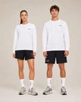 Model wearing Cuera Offcourt Logo Long Sleeve in White w. Green, lifestyle action shot on the padel court