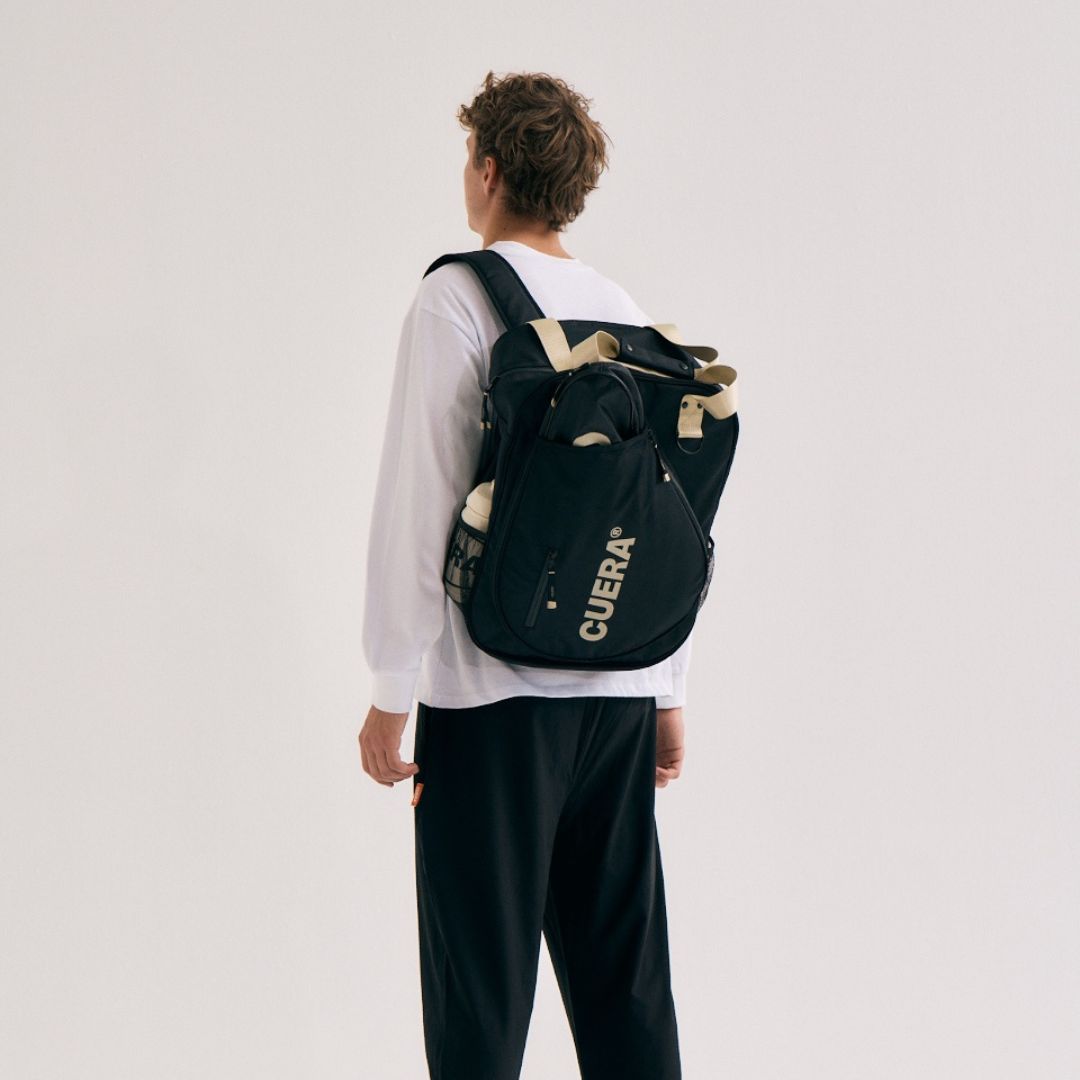 Model wearing Cuera Oncourt Bagpack small in Black, front studio view