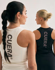 Model wearing Cuera Oncourt Black Dress Uniform, lifestyle action shot on the padel court