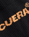 Cuera Oncourt Compression Sleeve in Black, logo print detail