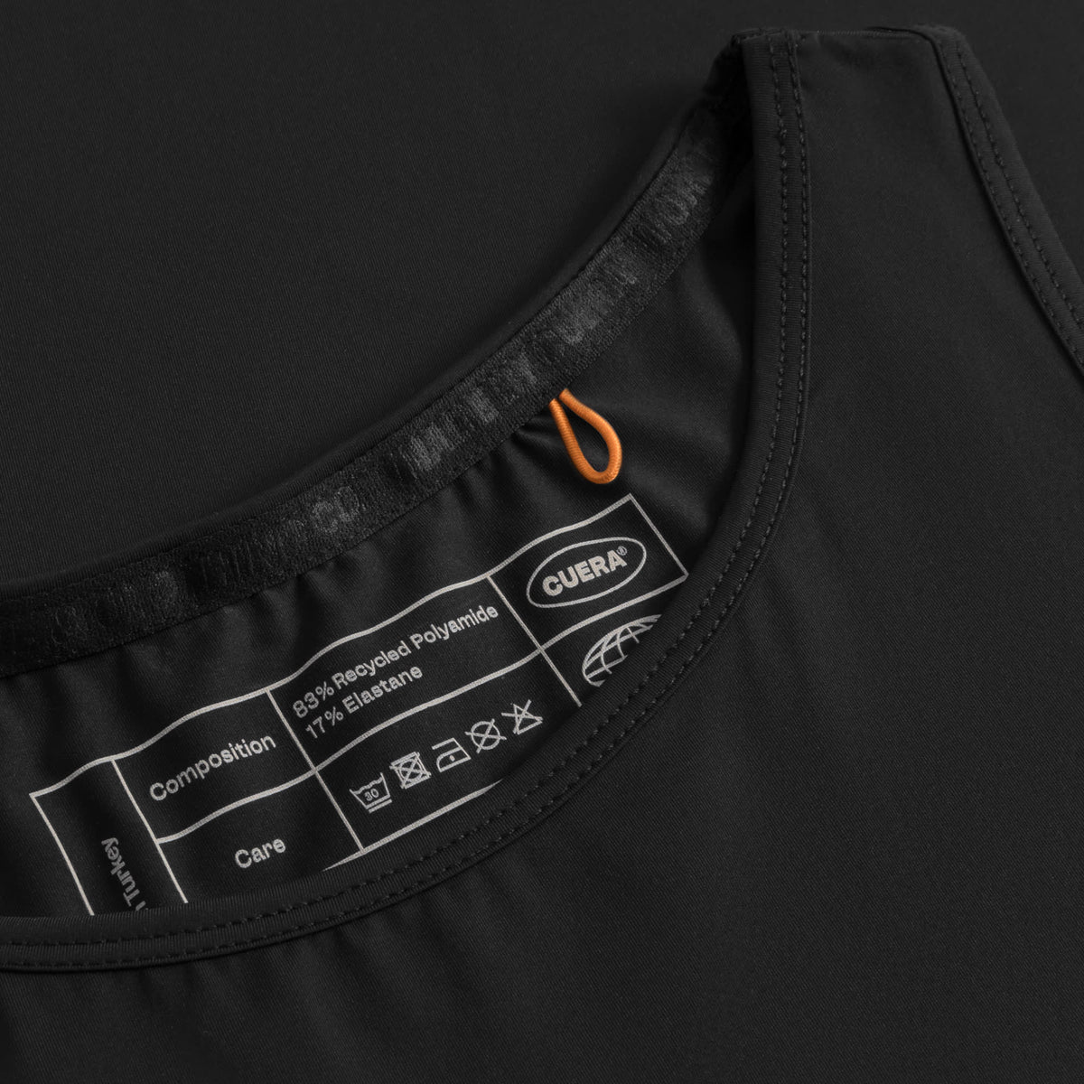 Cuera Oncourt Cropped Tank Top in Black, neck label and care tag detail