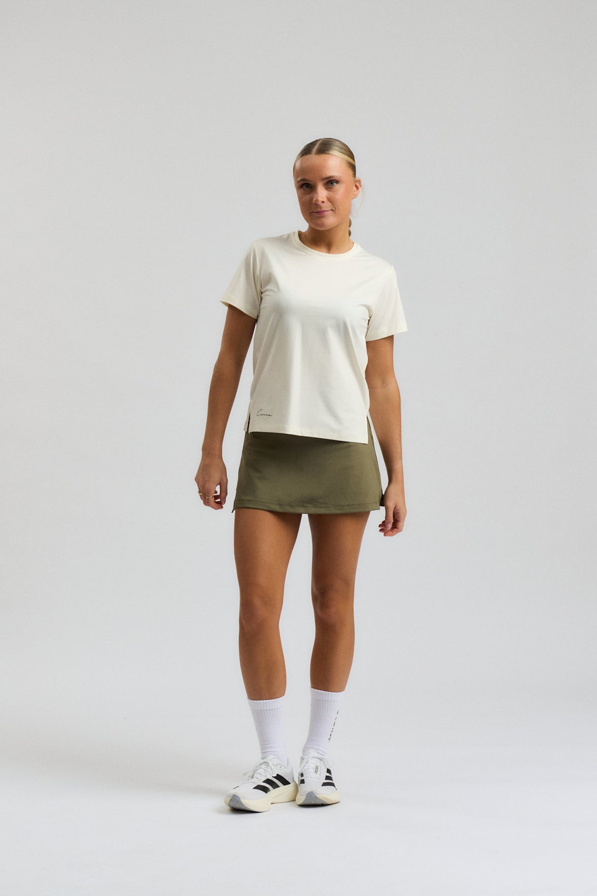 Model wearing Cuera Oncourt Cuera Skirt 2-in-1 in Army, close-up detail on model