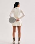 Model wearing Cuera Oncourt Cuera Skirt 2-in-1 in Off White, front studio view