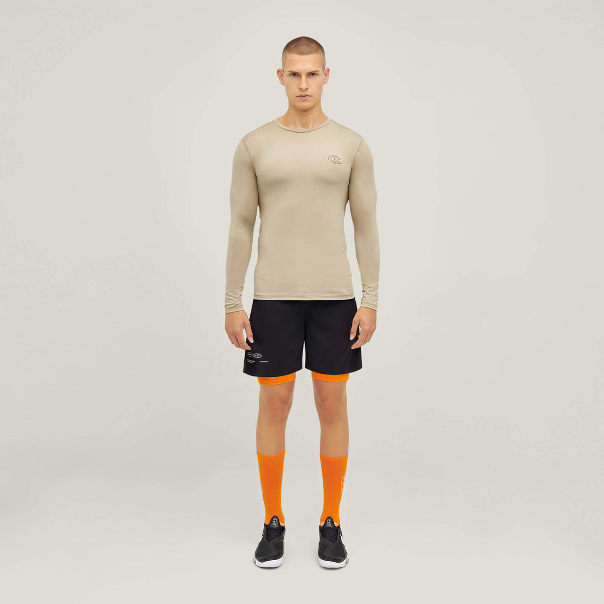 Model wearing Cuera Oncourt LS Layer T-Shirt in Sand, front studio view