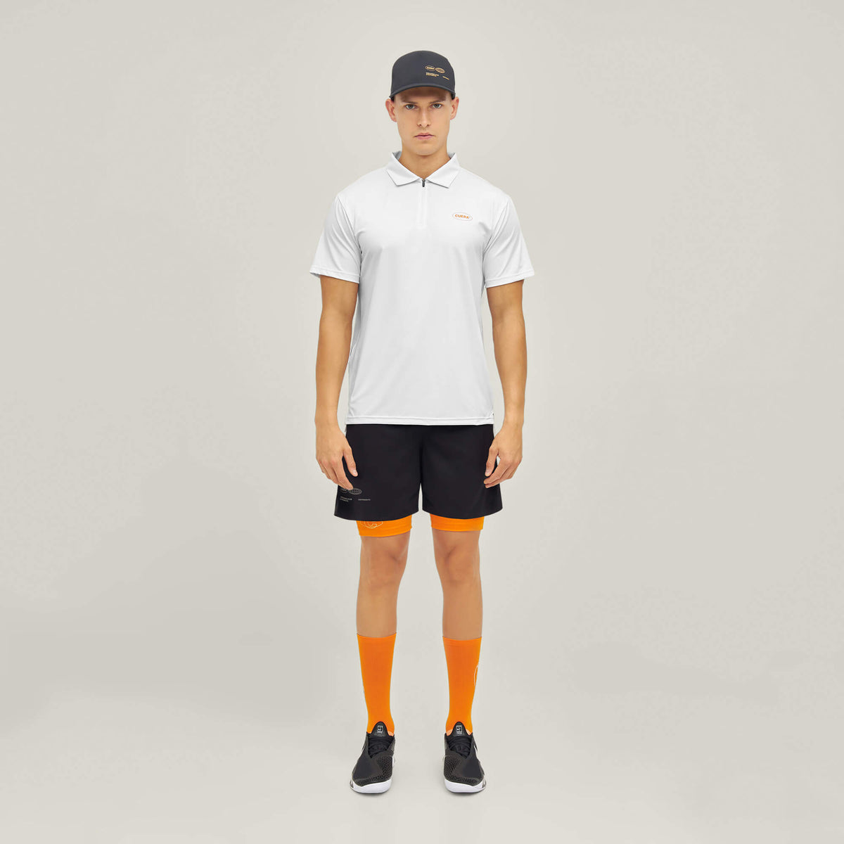 Model wearing Cuera Oncourt Made Polo ss in White, front studio view