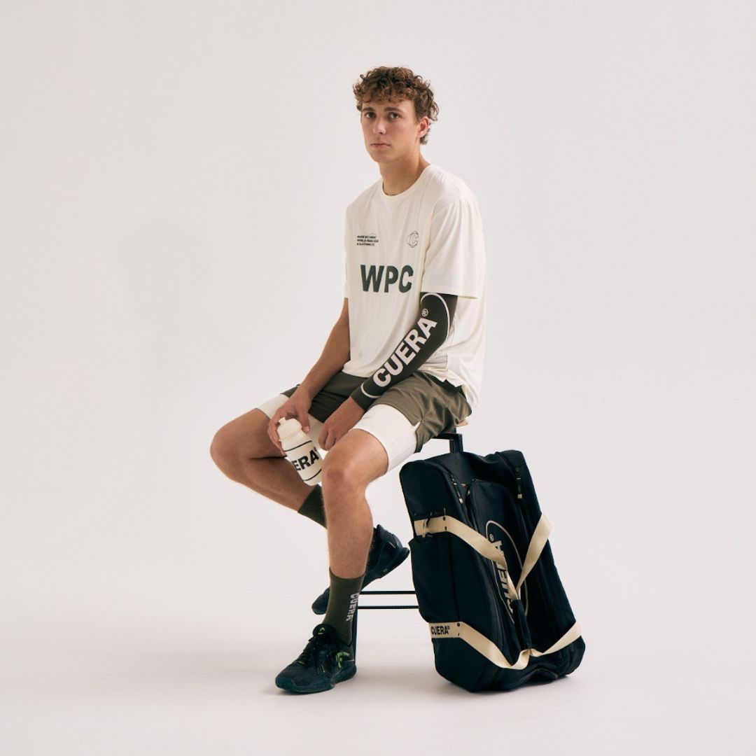 Model with Cuera Oncourt Premium Padel Bag in Black, lifestyle action shot on the padel court