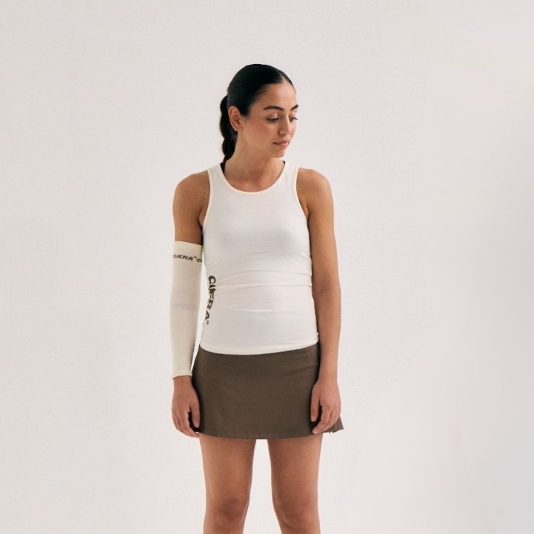 Model wearing Cuera Oncourt Slim Tank Top in Off White, close-up detail on model